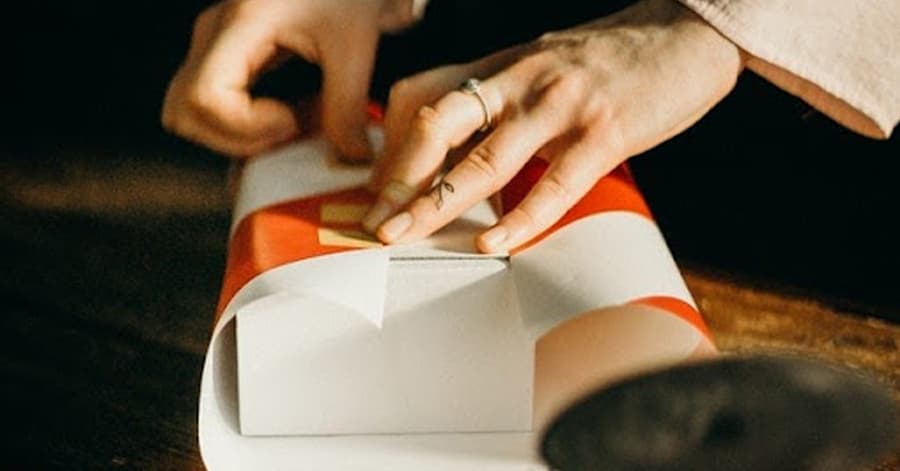 hands wrapping a present.