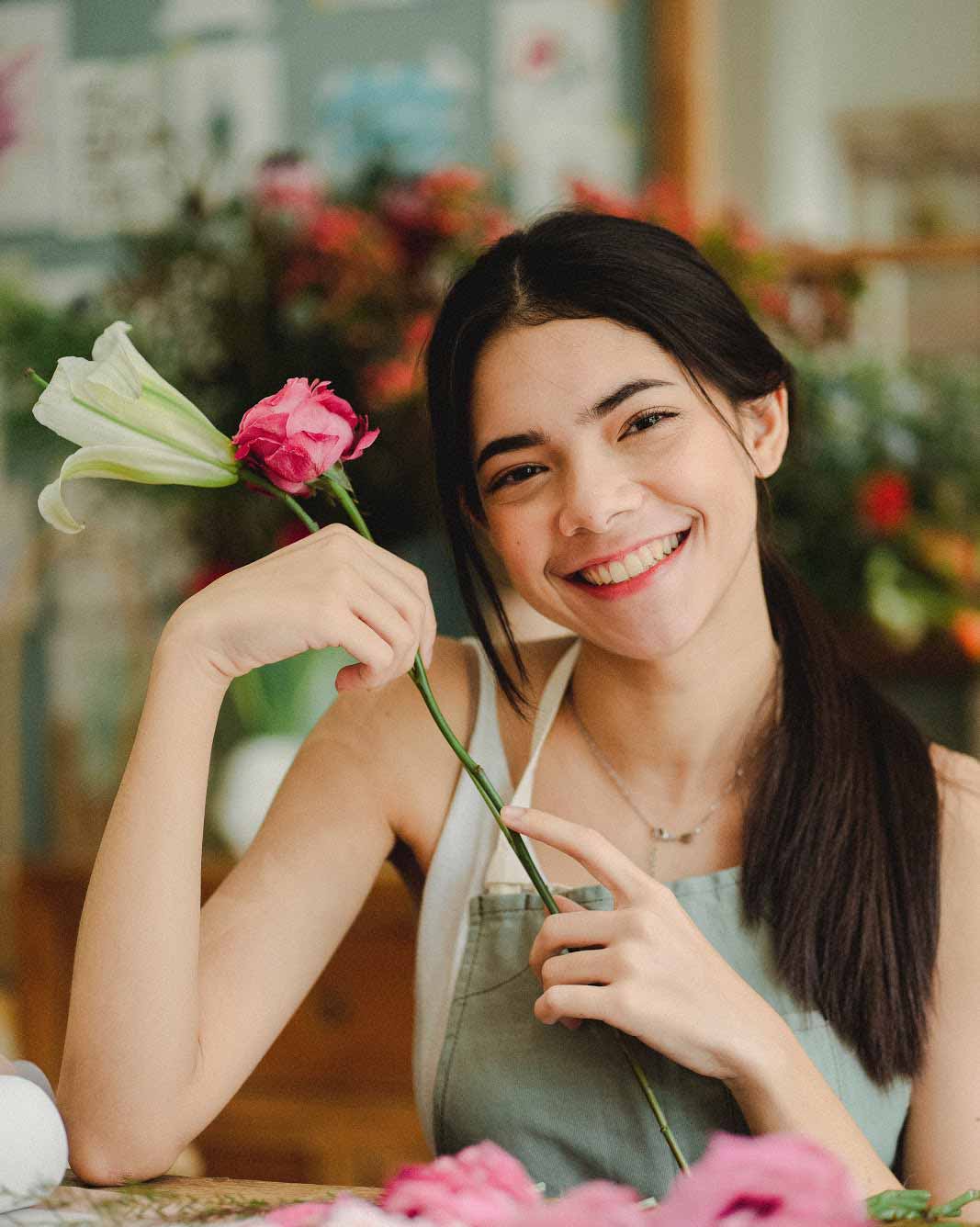 latina holding pink flower