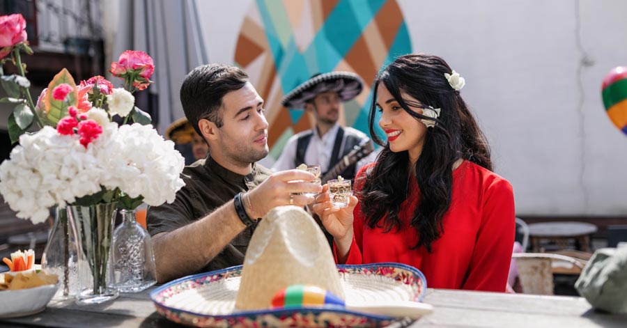 mexican couple toasting shots